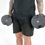 Fitness Model Using BRAINGAIN 40kg Round Adjustable Dumbbells Standing With Dumbbells By Side